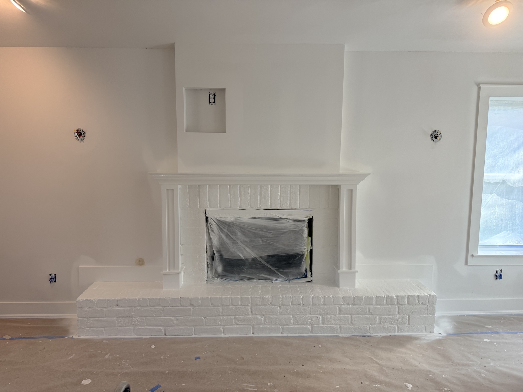 Fireplace opening masked and floor covered during preparation of the Favorite Things living room