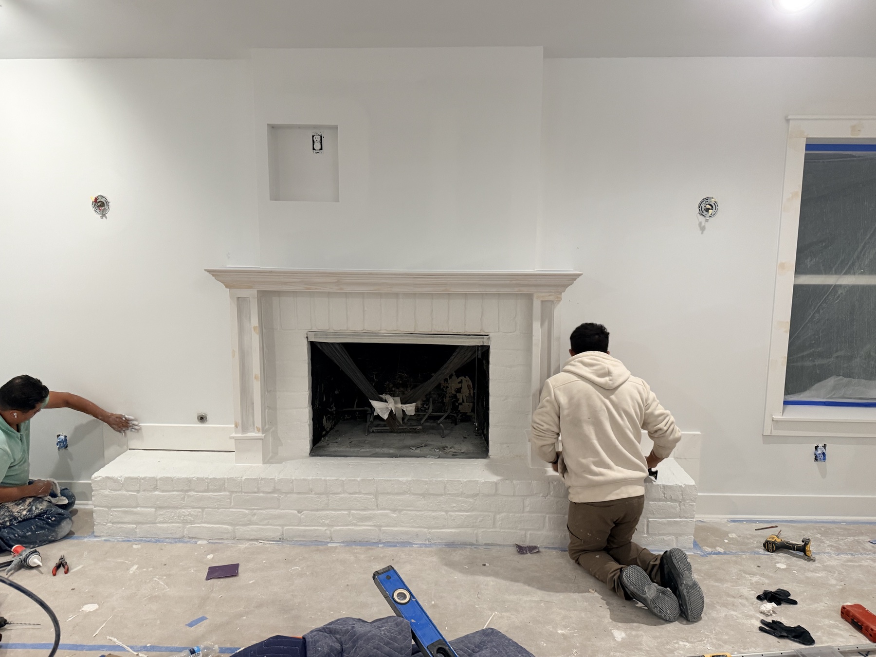 Sacred Innovations crew working on the custom mantel during the Favorite Things room renovation